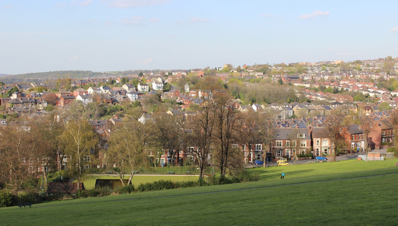 Parkland with a bowling green and Heeley's Victorian terraces rising up the hillside